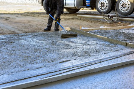 During construction of new house driveway, wet cement has been poured concrete