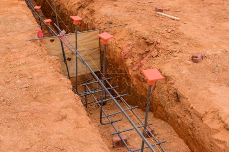 Photo for Concrete foundations are being poured into trenches dug during trench digging - Royalty Free Image
