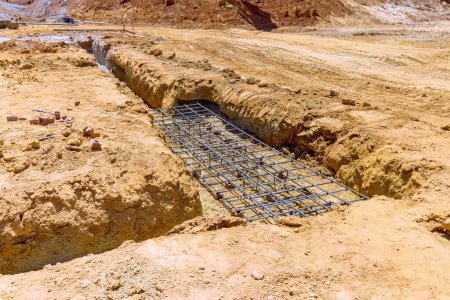 Travaux de terrassement, creusement d'une tranchée de terre creusée pour les fondations pour couler du béton