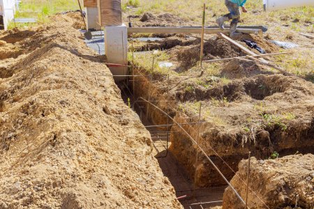 Photo for Construction an earthen trench the foundation as well as pouring of concrete slab - Royalty Free Image