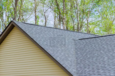 Newly built house roof top is covered with asphalt shingles