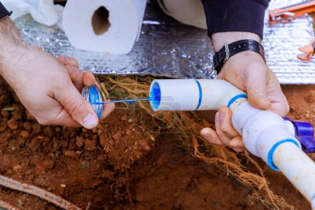 Photo for Glue applied to pvc pipe by plumber before it is glued - Royalty Free Image