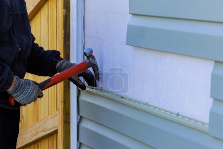 Photo for Replacing plastic siding on an exterior wall of residence house - Royalty Free Image