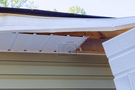 In aftermath of hurricane, master makes repairs to fascia trim