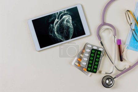 In hospital setting cardiology physician examines render of patients heart using 3D x-ray radiology scan on digital tablet
