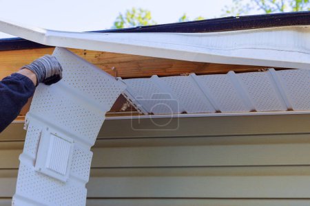 Photo for Master makes repairs after hurricane damages fascia trim - Royalty Free Image