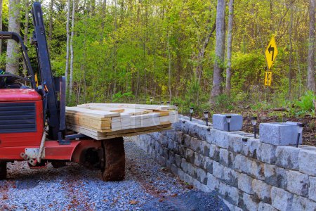 Using forklift, contractor delivers building materials on construction site