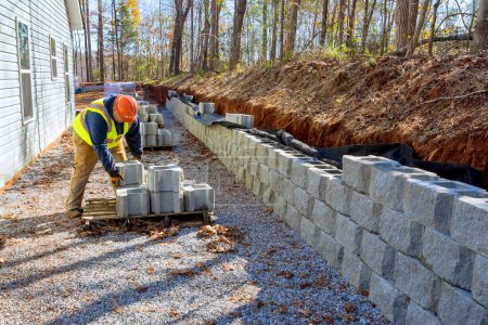 Photo for Installation of concrete block retaining walls was performed by contractor - Royalty Free Image