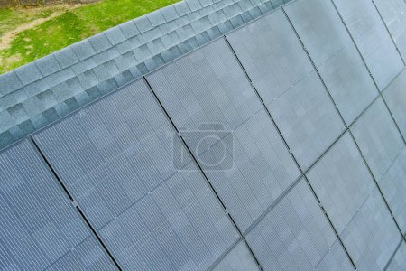 Photovoltaic panels installed on roof of house to generate renewable energy