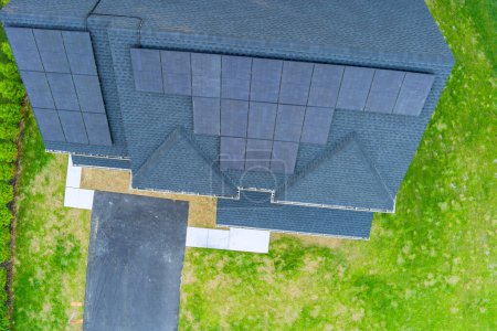 Photovoltaic panels on roof of house designed to produce green power renewable energy