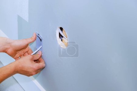 Photo for An electrician installed new current socket box during renovation of in apartment - Royalty Free Image