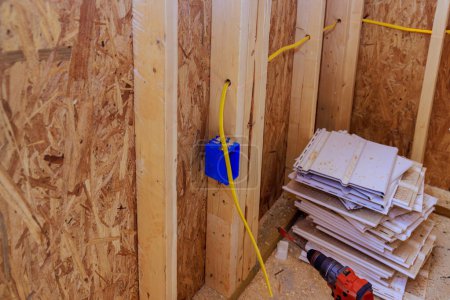 Ein Elektriker verlegt montierte Elektrokabel auf einer Baustelle