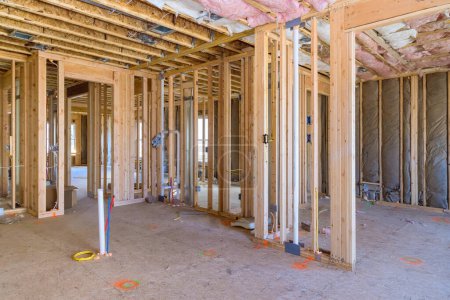 Photo for Under construction, new home is framing an unfinished wood frame with wooden trusses, posts, beams - Royalty Free Image