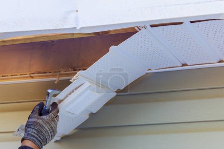 Immediately following hurricane, master makes repairs to fascia trim that was damaged