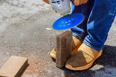 Master grind using circular diamond disc saw for paving bricks stones before installation