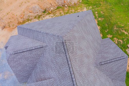 In construction phase of new house, roof is covered with rubber asphalt roof shingles