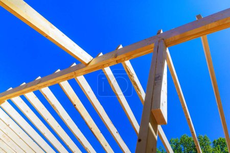 Building new house construction improvement consists of installing framing beams, wooden trusses