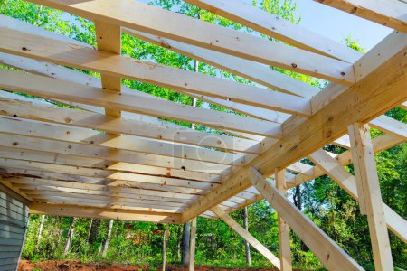 During remodeling house construction improvement installing framing beams wooden trusses unfinished