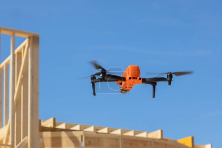 Contractor supervisor inspects work on construction site using drone