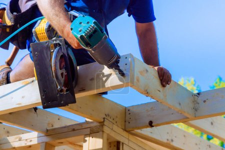 An air nail hammer is used by framing contractor to nail wooden beams