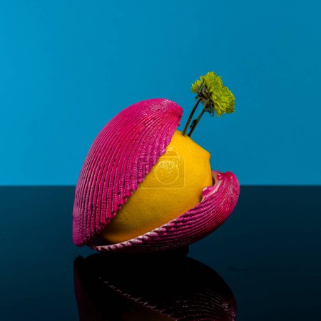 Photo for Creative still life with lemon and shells on a blue background - Royalty Free Image