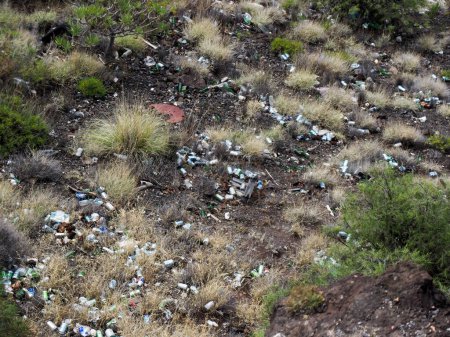 Tenerife, Spain: cigarette butts and rubbish bin thrown into nature