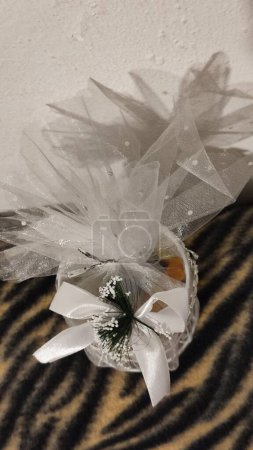 white wedding souvenir, candy box with ribbon, gift object. High quality photo