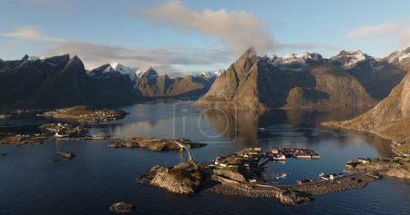 Aerial Panorama of Reine Village Surrounded by Lofotens Dramatic Peaks. High quality 4k footage