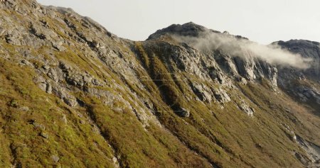 Ascend to the Clouds: Aerial Majesty of Lofotens Peaks. High quality 4k footage