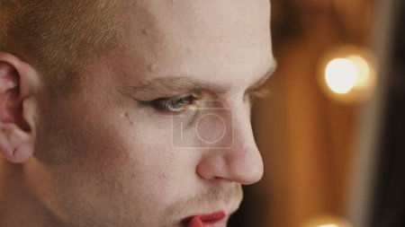 Close-Up of LGBT Individual Applying Lipstick in Mirror Reflection. High quality 4k footage