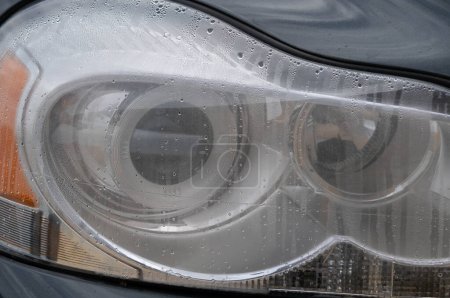 A right front car headlight with water inside. A typical problem with condensation in auto headlights.