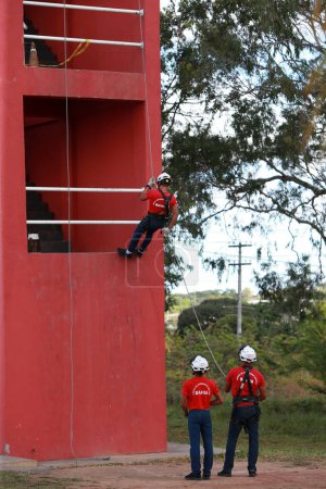 Photo for Simoes filho, bahia, brazil - november 11, 2022: Military firefighters from Bahia do abseiling climbing training at a barracks in the city of Simoes Filho. - Royalty Free Image