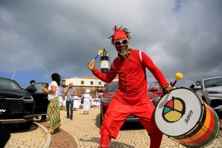 Photo for Salvador, bahia, brazil - july 4, 2023: musician from the band Olodum performs at Farol da Barra during the launch of the plant of the Chinese automaker BYD, which will open a factory in the city of Camacari. - Royalty Free Image