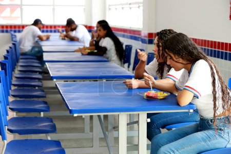 Photo for Euclides da cunha, bahia, brazil - setembro 18, 2023: students from a public school having a meal at the teaching unit. - Royalty Free Image
