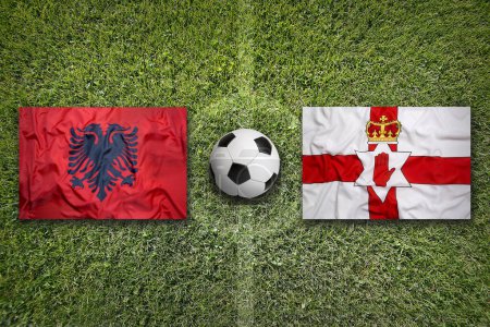 Albania vs. Northern Ireland flags on green soccer field