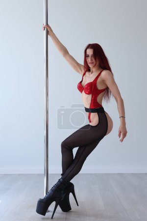 Photo for Young flexible girl practicing on the pylon - Royalty Free Image