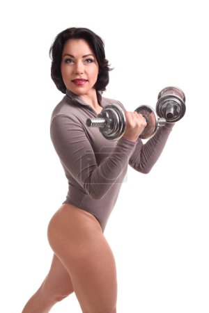 Photo for Beautiful fitness woman lifting dumbbells on a white background - Royalty Free Image