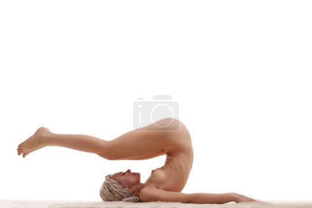 Foto de Young woman naked yoga on white background - Imagen libre de derechos