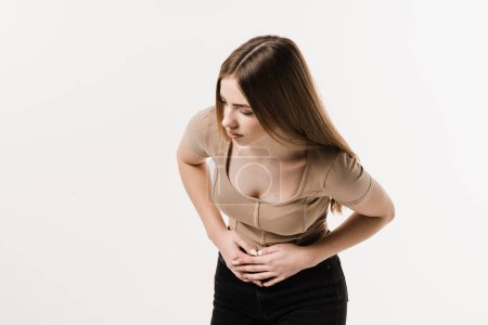 Photo for Cancer of stomach and esophagus of girl. Sick young woman is holding her stomach because it hurts. Pancreatitis disease of pancreas becomes inflamed - Royalty Free Image