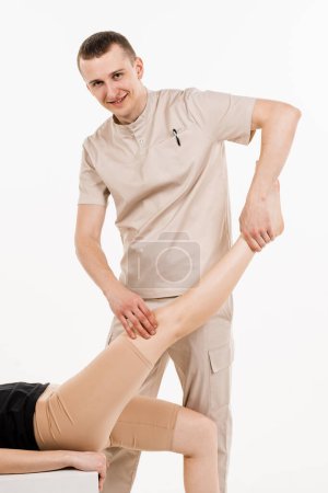 Photo for Orthopedist is touching and pressing knee for assessment of the volume of physiological movements. Examination of knee mobilisations. Knee joint and meniscus injury - Royalty Free Image