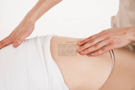 Photo for Scoliosis is sideways curvature of the spine. Orthopedic traumatologist examines scoliosis of spine on white background - Royalty Free Image