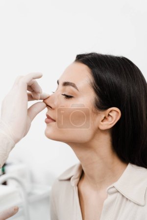 ENT consultation before rhinoplasty plastic surgery. Rhinoplasty is surgical procedure that involves altering shape of nose to improve appearance and enhance breathing