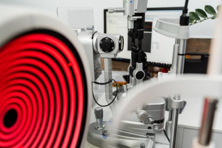 Corneal topographer shines red light and slit lamp for topography examination. Corneal topography eye vision test for visual description of the shape and power of the cornea