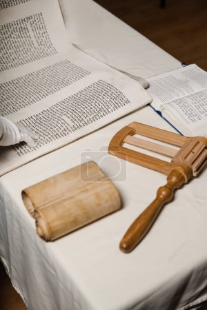 Photo for Jewish grogger noisemaker and Hebrew bible for praying and celebration Purim festival. Purim Jewish religious holiday of Israel - Royalty Free Image