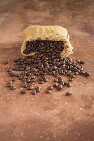 Photo for Coffee beans in a bag on a wooden background - Royalty Free Image
