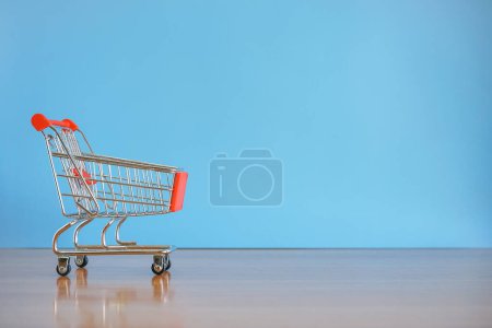 Photo for Shopping cart with blue background. - Royalty Free Image
