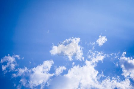 Photo for Beautiful white fluffy clouds on the blue clear sky, background - Royalty Free Image