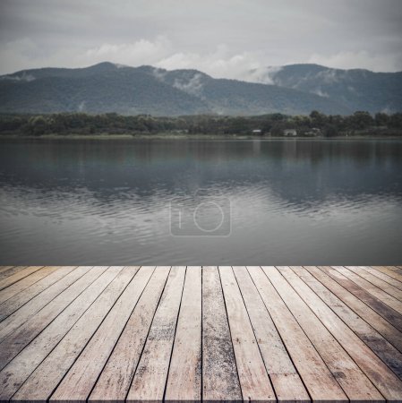Photo for Wooden table with blurred lake background - Royalty Free Image