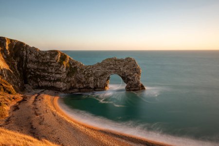 Photo for Long exposure of the calm sea at Durdle Door at dusk - Royalty Free Image