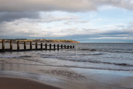 Photo for Landscape photo of a groyne in the sea at Dawlish Warren nature reserve with Exmouth in the background - Royalty Free Image